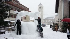 il team di artisti della Mongolia lavora attorno alla scultura di neve in piazza Senfter a San candido © massimo manfregola/ masman