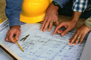 Hands of Couple Looking at Blueprints